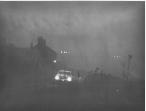 Taxi leaving foggy Hotel